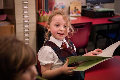 A child in a school reading a book